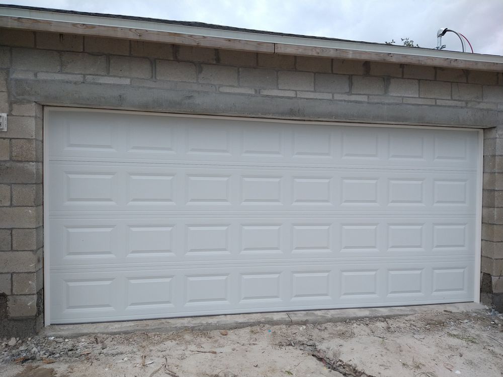 Technician performing a close-up garage door opener repair.